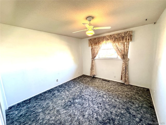 empty room with a textured ceiling, carpet floors, visible vents, and ceiling fan
