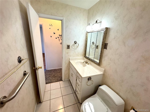 half bathroom with toilet, vanity, and tile patterned floors