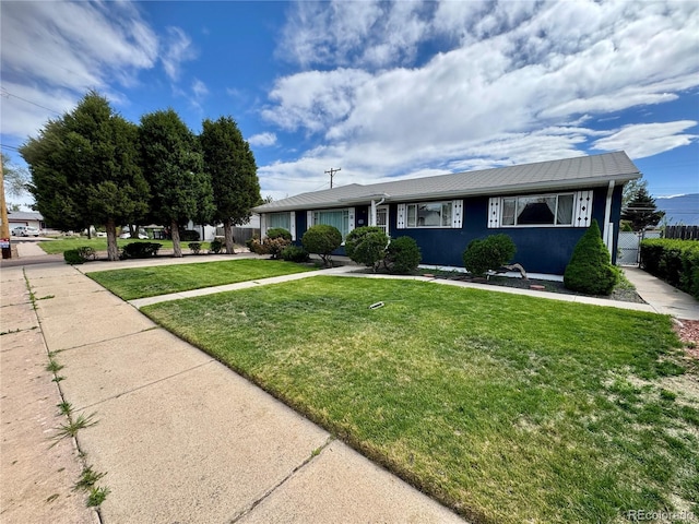 3498 Corbett Ln, Colorado Springs, CO 80907 - ranch-style house with a front yard and a gate