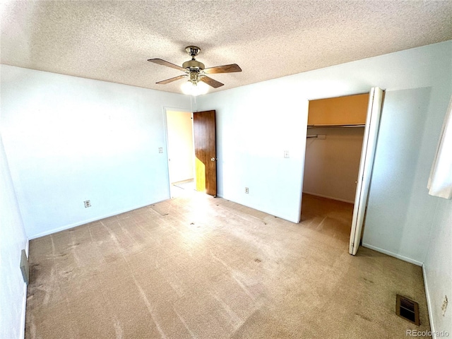 3498 Corbett Ln, Colorado Springs, CO 80907 - unfurnished bedroom featuring a textured ceiling, carpet floors, a closet, a spacious closet, and ceiling fan