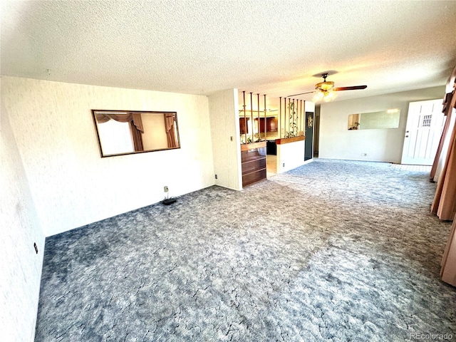 3498 Corbett Ln, Colorado Springs, CO 80907 - unfurnished living room with carpet flooring, a textured ceiling, and a ceiling fan