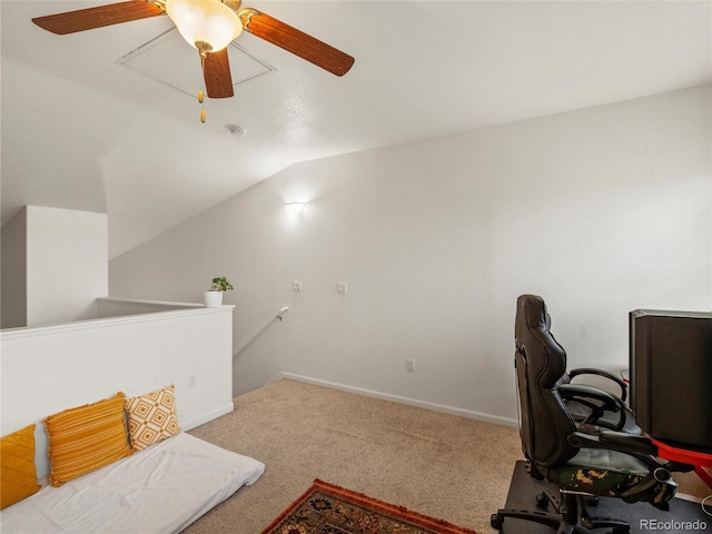 carpeted home office featuring vaulted ceiling, ceiling fan, and baseboards