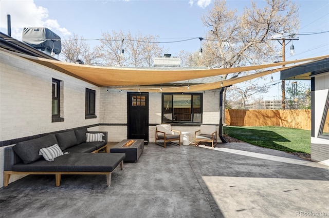 view of patio featuring fence and an outdoor living space with a fire pit