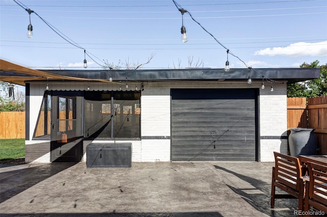 garage featuring central AC, fence, and driveway