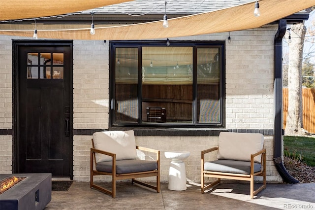 view of patio with fence and a fire pit