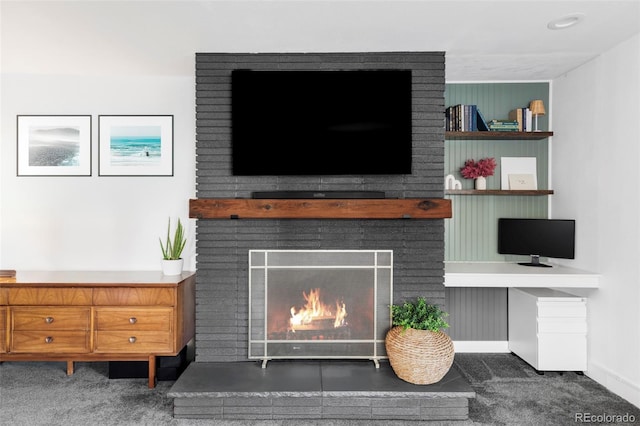room details featuring carpet floors, baseboards, and a brick fireplace
