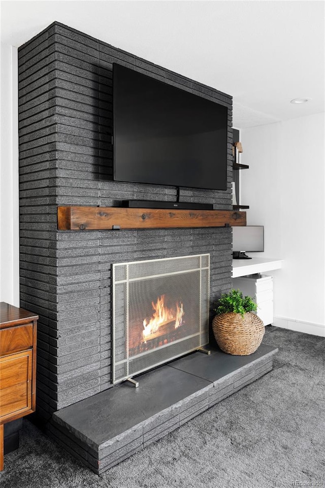 details with carpet, baseboards, and a fireplace