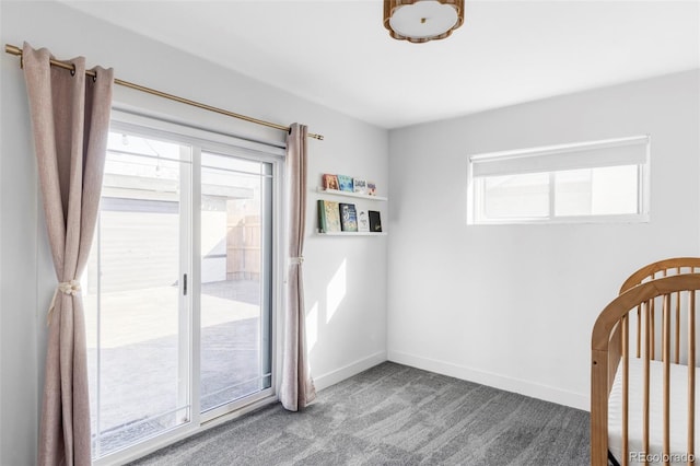 unfurnished bedroom featuring baseboards, carpet flooring, and multiple windows