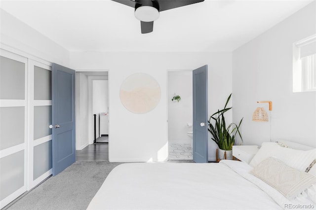 bedroom with carpet flooring, connected bathroom, and a ceiling fan