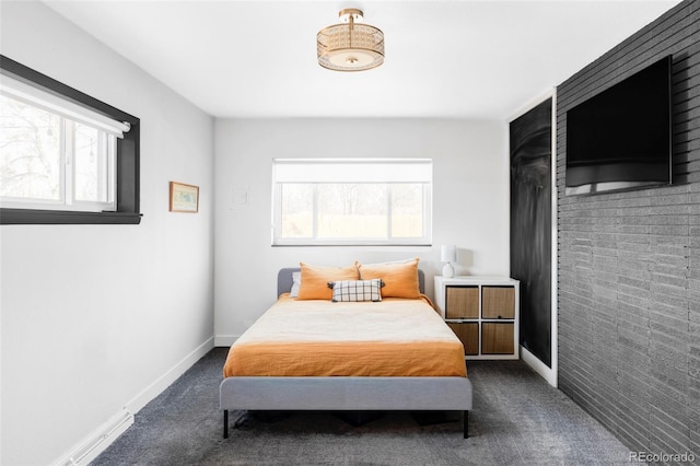 bedroom featuring dark colored carpet, baseboards, and multiple windows