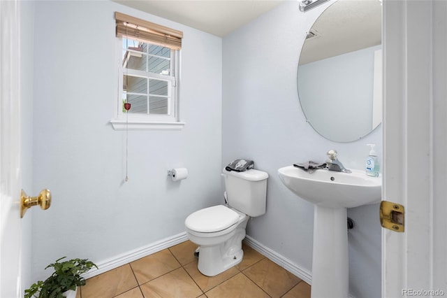 4184 Netherland St, Denver, CO 80249 - half bathroom featuring toilet, tile patterned floors, and baseboards