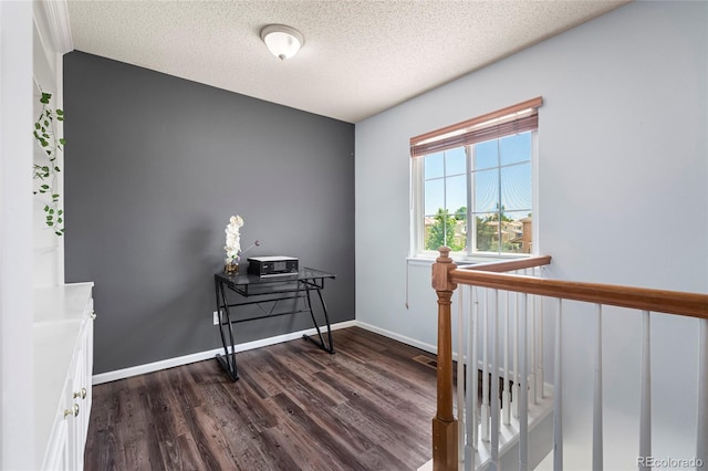 4184 Netherland St, Denver, CO 80249 - corridor with dark wood-style floors, a textured ceiling, and baseboards