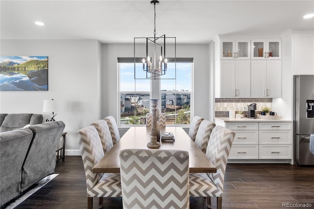 dining space featuring a chandelier, dark wood finished floors, recessed lighting, and baseboards