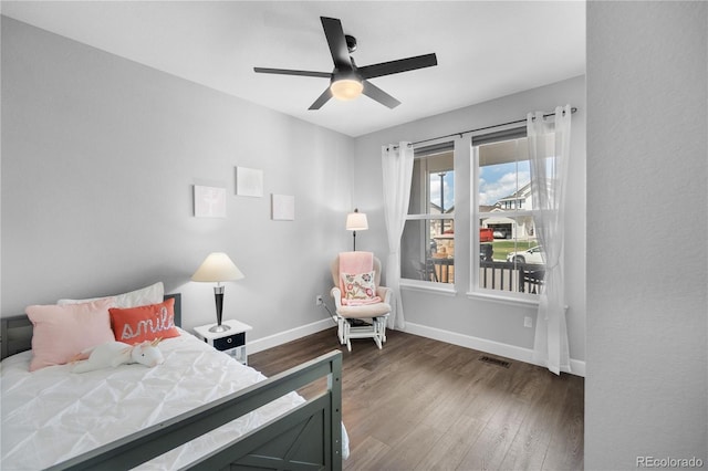 bedroom featuring wood finished floors, baseboards, and a ceiling fan