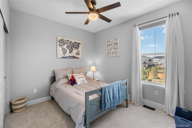 bedroom featuring multiple windows, carpet flooring, and baseboards