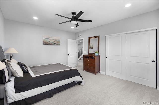 bedroom with light colored carpet, recessed lighting, a closet, a ceiling fan, and baseboards