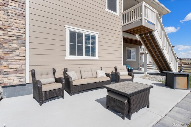 view of patio / terrace with stairway, outdoor lounge area, and a wooden deck