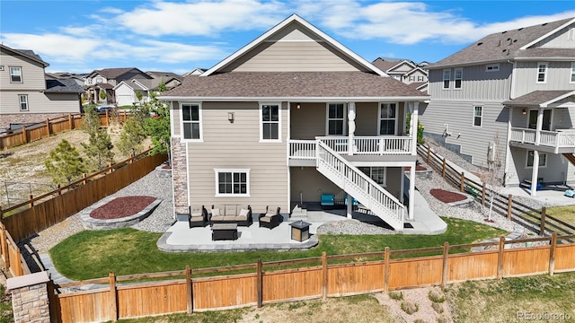 back of house with outdoor lounge area, a residential view, a patio area, a shingled roof, and stairway
