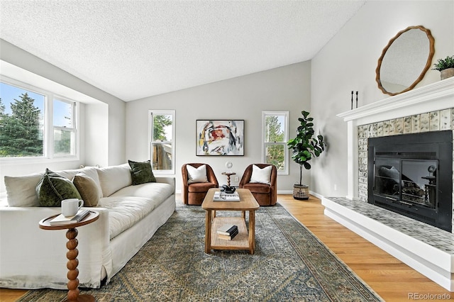 1092 E 16th Ave, Broomfield, CO 80020 - living room with lofted ceiling, a textured ceiling, wood finished floors, and a fireplace