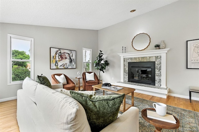 1092 E 16th Ave, Broomfield, CO 80020 - living room with wood finished floors, a fireplace, a textured ceiling, and vaulted ceiling