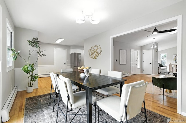 1092 E 16th Ave, Broomfield, CO 80020 - dining space featuring a baseboard heating unit, light wood-style flooring, and a chandelier