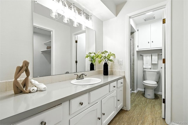 1092 E 16th Ave, Broomfield, CO 80020 - bathroom featuring vanity, wood finished floors, and a shower