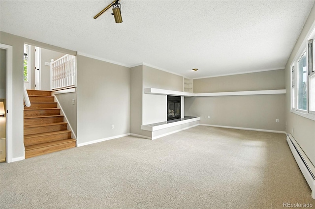 1092 E 16th Ave, Broomfield, CO 80020 - unfurnished living room featuring a baseboard radiator, a textured ceiling, a glass covered fireplace, stairway, and carpet flooring