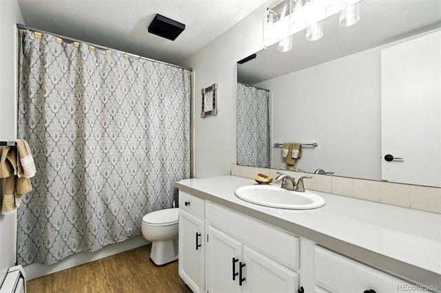1092 E 16th Ave, Broomfield, CO 80020 - bathroom featuring wood finished floors, vanity, and baseboard heating
