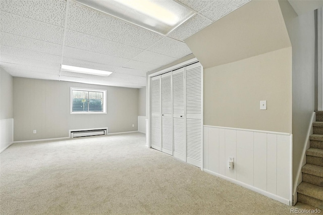 1092 E 16th Ave, Broomfield, CO 80020 - below grade area with a baseboard heating unit, stairway, carpet, and a paneled ceiling