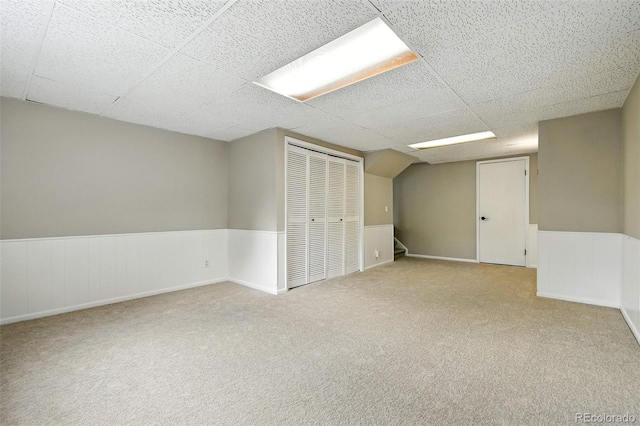 1092 E 16th Ave, Broomfield, CO 80020 - finished basement featuring a paneled ceiling, carpet flooring, wainscoting, and stairs