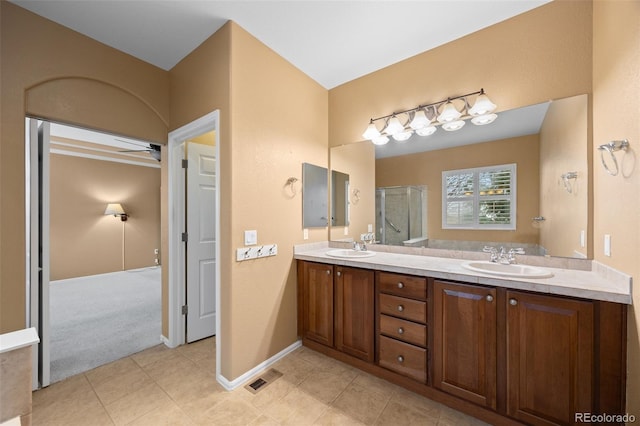 full bath featuring double vanity, visible vents, a shower stall, and a sink