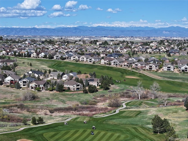 aerial view with a residential view, a mountain view, and golf course view