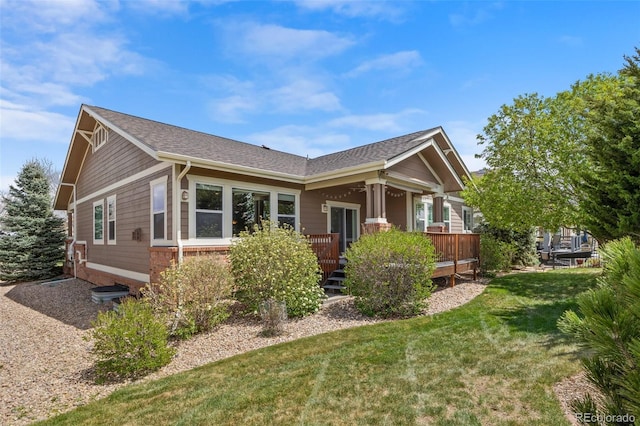 view of front of home with a deck and a front yard