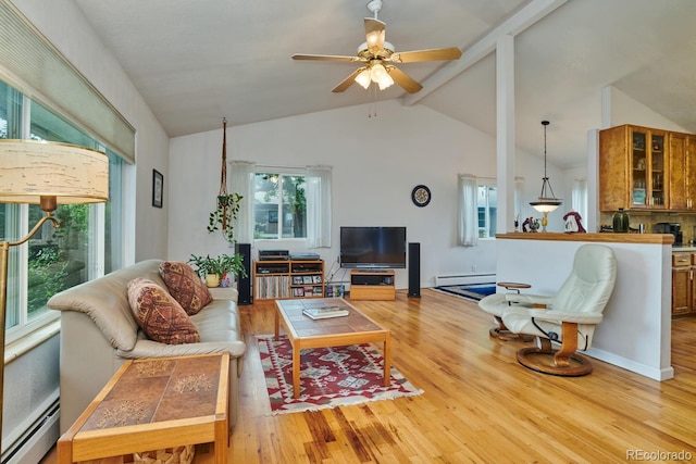 living room with a baseboard heating unit, light hardwood / wood-style floors, and vaulted ceiling with beams