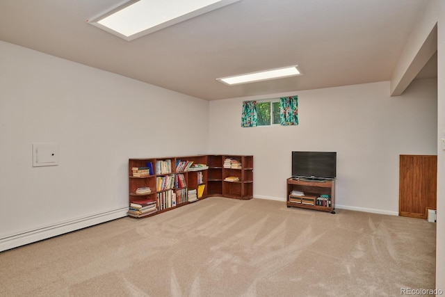 interior space with a baseboard heating unit and carpet