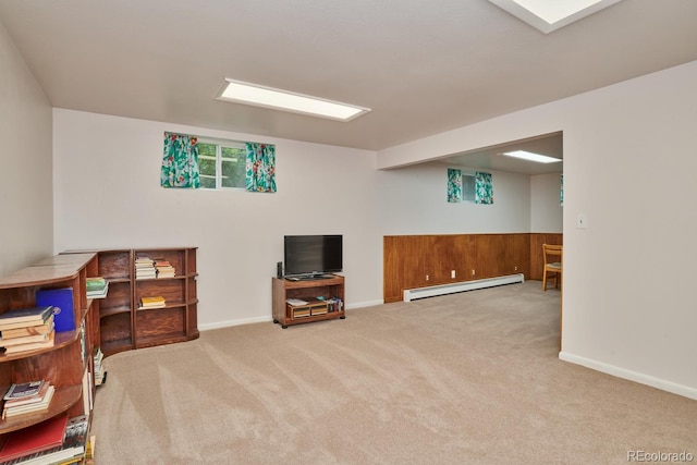 basement featuring light colored carpet and a baseboard heating unit