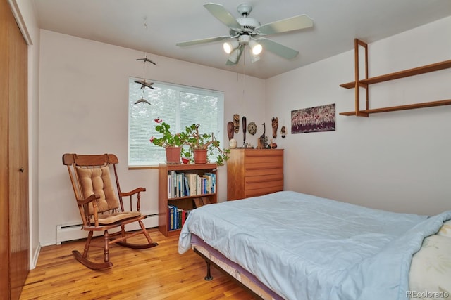 bedroom featuring baseboard heating, ceiling fan, and light wood-type flooring