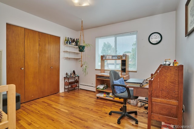 office with a baseboard radiator and light hardwood / wood-style flooring