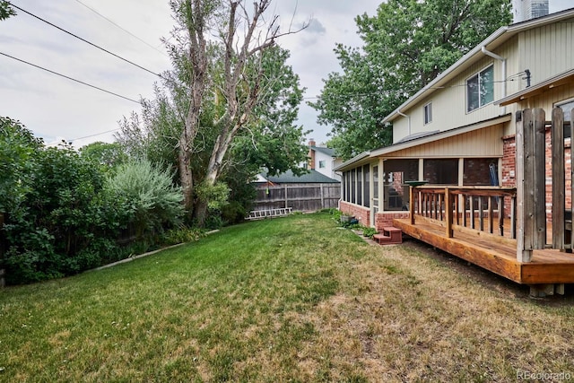 view of yard featuring a wooden deck and a sunroom