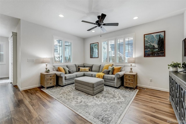 living room featuring recessed lighting, wood finished floors, and baseboards