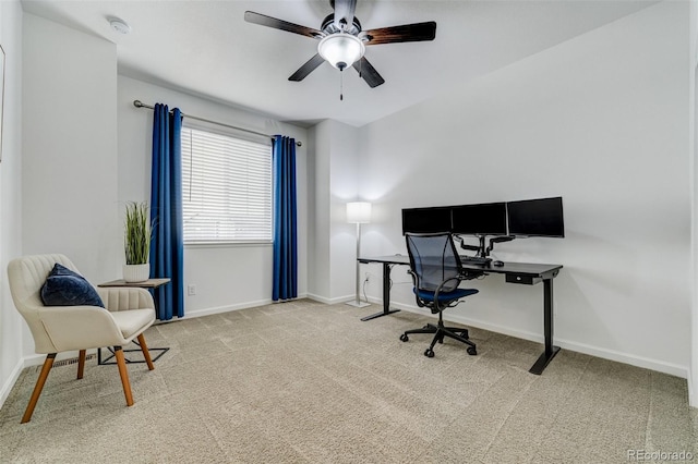 carpeted office with ceiling fan and baseboards