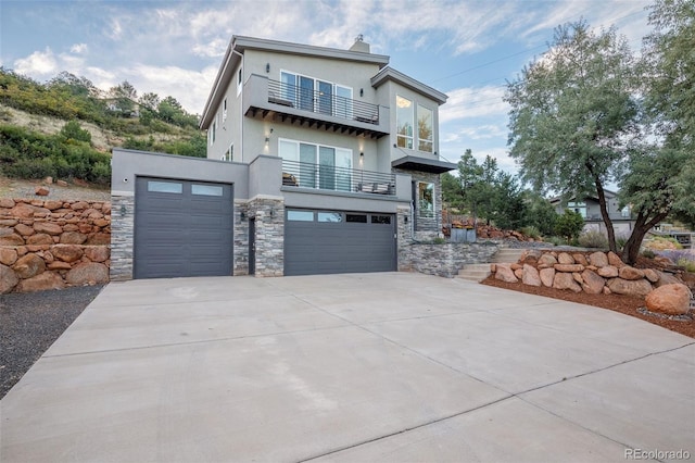 contemporary home with a balcony and a garage