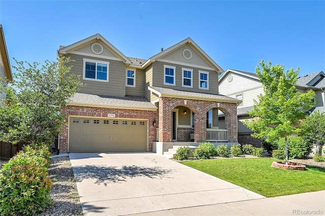 25486 E 4th Pl, Aurora, CO 80018 - view of front of house featuring a porch, brick siding, an attached garage, driveway, and a front lawn