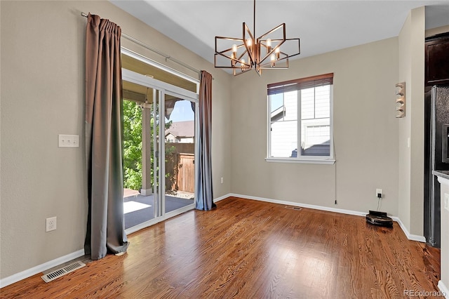 25486 E 4th Pl, Aurora, CO 80018 - unfurnished dining area featuring a chandelier and wood finished floors