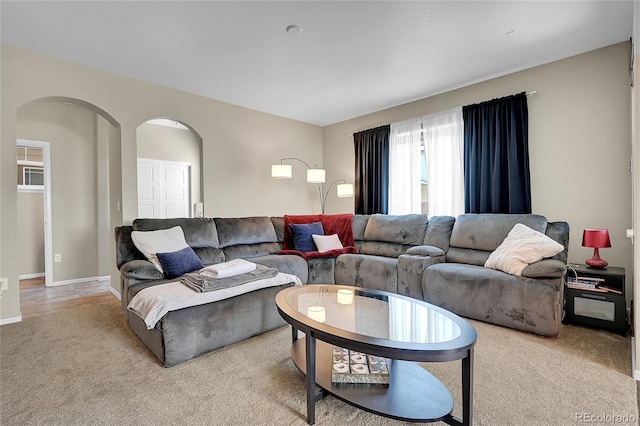 25486 E 4th Pl, Aurora, CO 80018 - living room featuring arched walkways and carpet floors