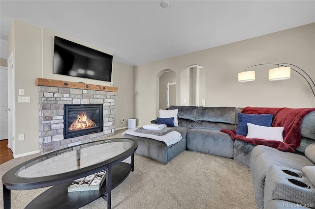 25486 E 4th Pl, Aurora, CO 80018 - carpeted living area featuring a stone fireplace and arched walkways