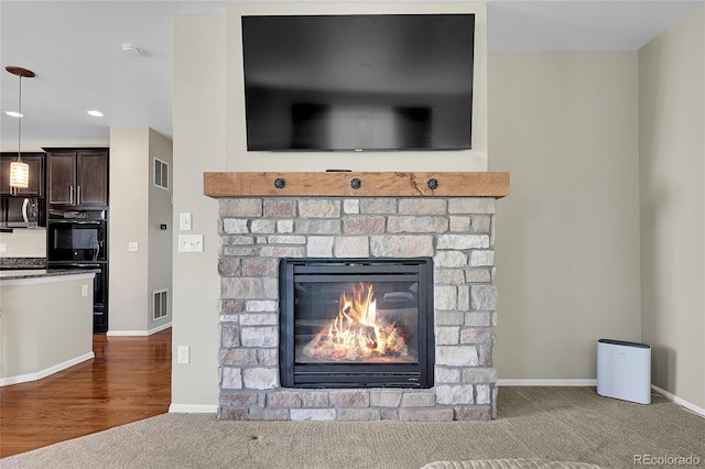 25486 E 4th Pl, Aurora, CO 80018 - detailed view of a fireplace, carpet, stainless steel microwave, and recessed lighting