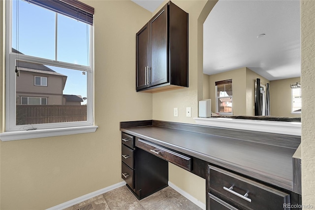 25486 E 4th Pl, Aurora, CO 80018 - kitchen featuring dark brown cabinets and arched walkways