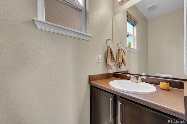 25486 E 4th Pl, Aurora, CO 80018 - bathroom featuring vanity and a textured wall
