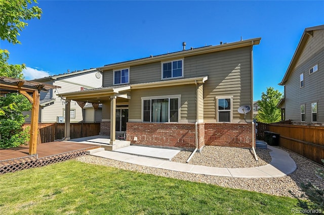 25486 E 4th Pl, Aurora, CO 80018 - back of house with brick siding, a fenced backyard, a deck, and a patio